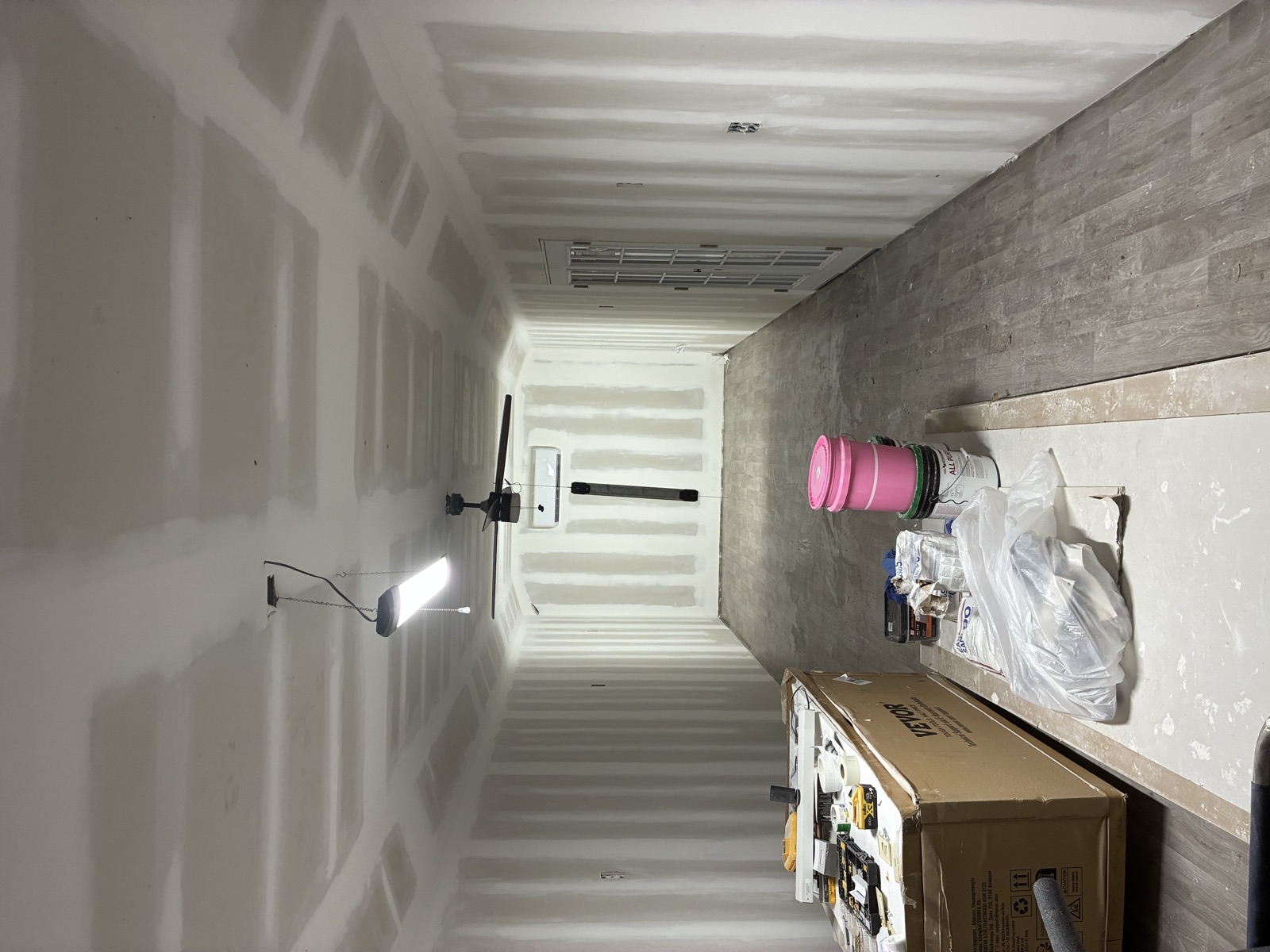 Drywall hung and taped throughout a long interior space